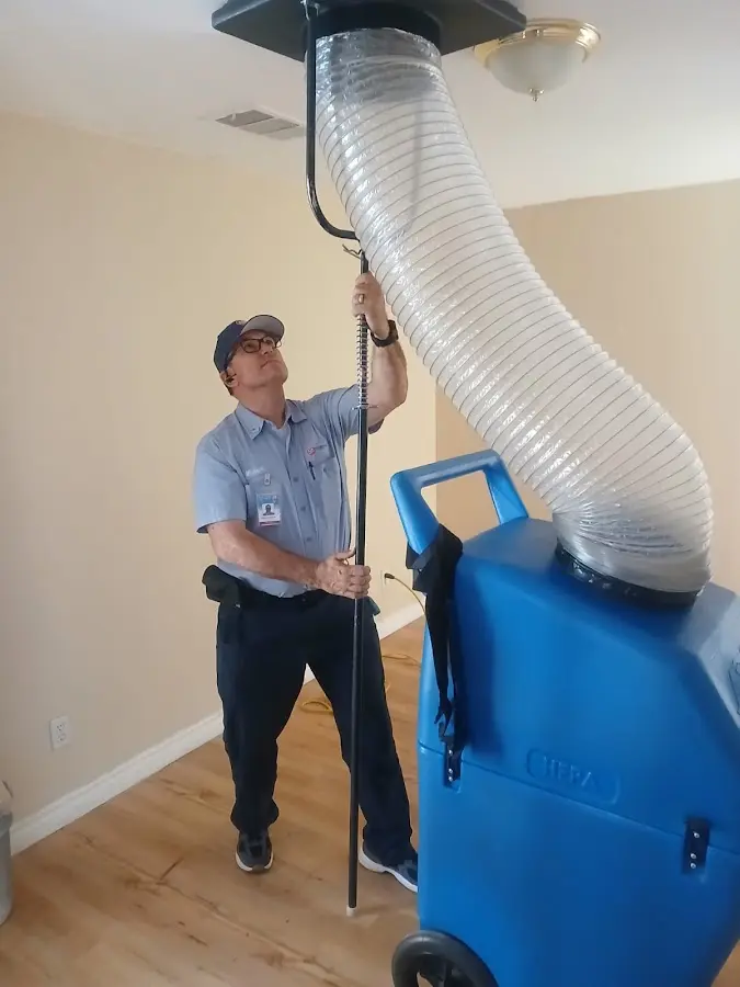 Furnace Tune-Up technician using HEPA equipment in Farmville